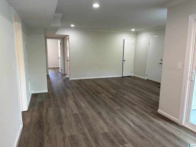 unfurnished room with recessed lighting, baseboards, dark wood finished floors, and ornamental molding