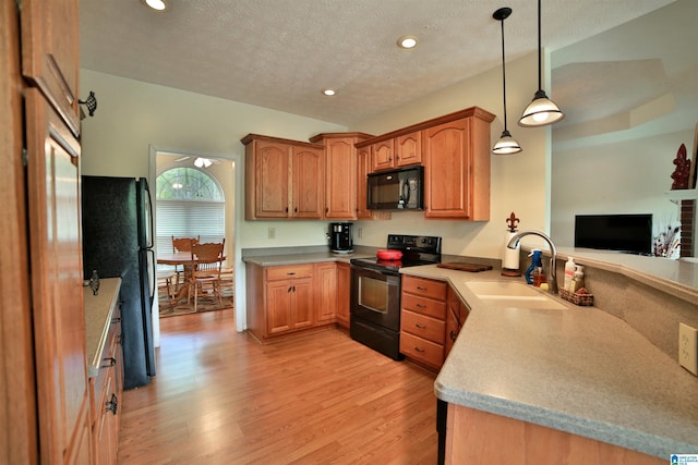 50 County Road 4311, Wedowee, AL 36278 - kitchen featuring a sink, a textured ceiling, light wood-style flooring, pendant lighting, and black appliances