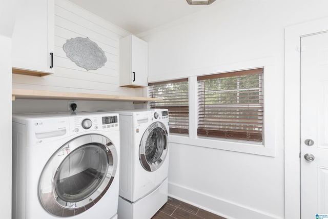 laundry room with wooden walls, separate washer and dryer, cabinet space, and dark wood-type flooring