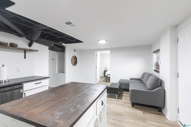 kitchen featuring visible vents, tasteful backsplash, open shelves, stainless steel dishwasher, and light wood-type flooring