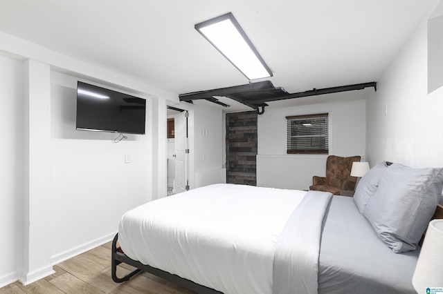 bedroom featuring baseboards and light wood-style flooring