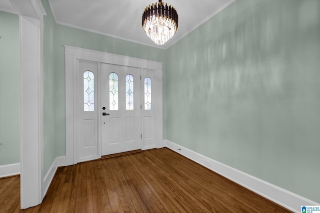 829 1st St SW, Birmingham, AL 35211 - foyer with dark wood-style flooring, baseboards, a chandelier, and ornamental molding