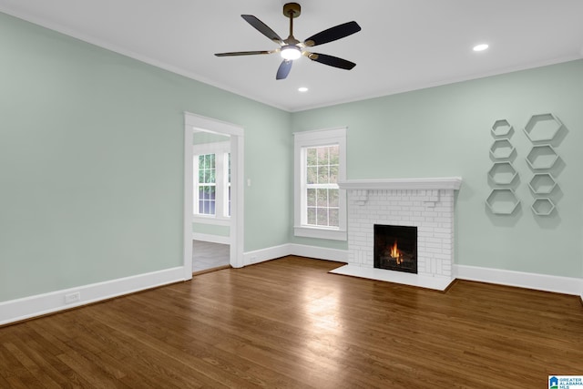 829 1st St SW, Birmingham, AL 35211 - unfurnished living room with a fireplace, ceiling fan, wood finished floors, baseboards, and crown molding