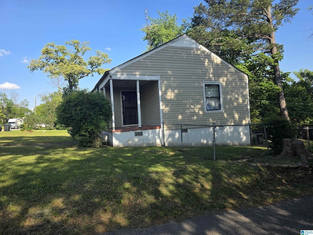 view of side of property with a lawn, crawl space, and fence