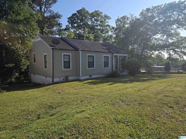view of front of home with a front yard and crawl space