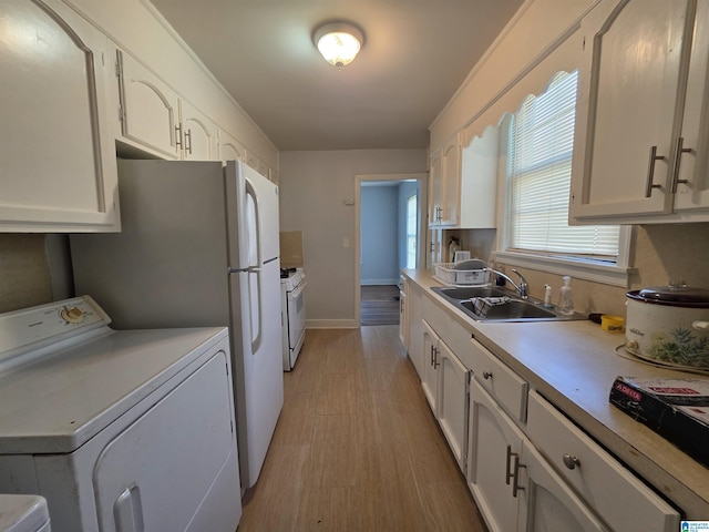 kitchen with washer / clothes dryer, white gas range, light countertops, white cabinetry, and a sink