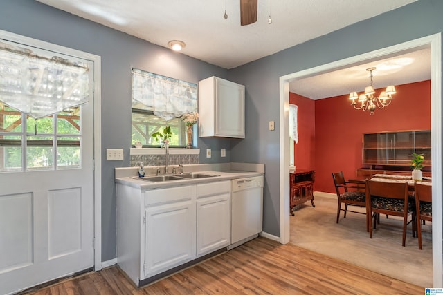kitchen featuring a sink, white cabinetry, dishwasher, and a healthy amount of sunlight