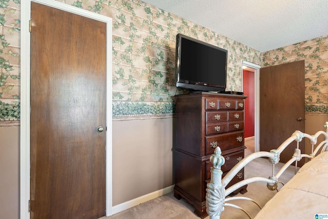 home office with baseboards, carpet flooring, a textured ceiling, and wallpapered walls