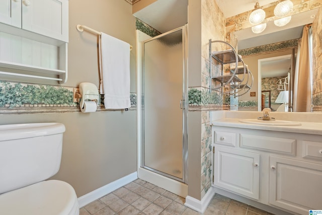 bathroom featuring baseboards, vanity, toilet, and a shower stall