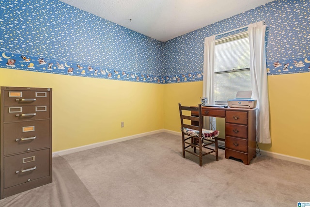 carpeted office space with wallpapered walls and baseboards