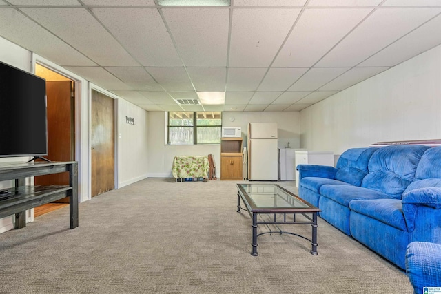 living room with visible vents, carpet flooring, and a drop ceiling