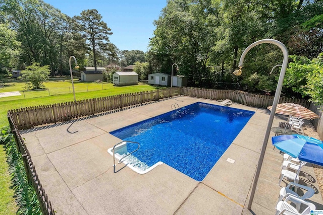 view of swimming pool featuring a diving board, a fenced in pool, a fenced backyard, a yard, and a patio