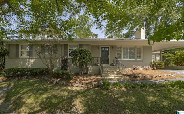 1856 Southwood Rd, Vestavia Hills, AL 35216 - ranch-style house with brick siding, an attached carport, a front yard, and a chimney