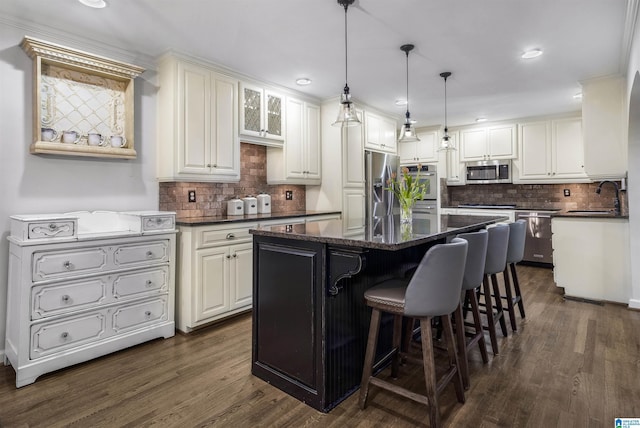 1856 Southwood Rd, Vestavia Hills, AL 35216 - kitchen featuring a kitchen island, appliances with stainless steel finishes, a sink, and tasteful backsplash