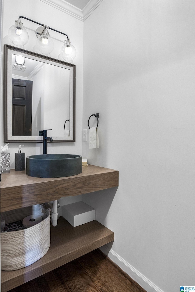 1856 Southwood Rd, Vestavia Hills, AL 35216 - bathroom featuring a sink, baseboards, crown molding, and visible vents