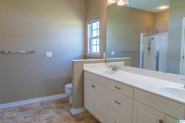 full bathroom with toilet, baseboards, a sink, and a stall shower