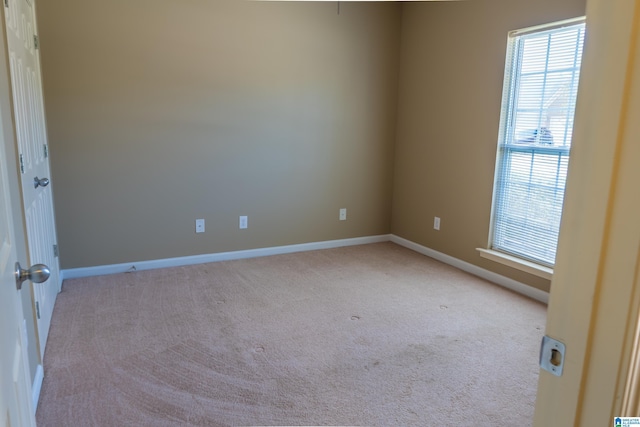 carpeted spare room with baseboards