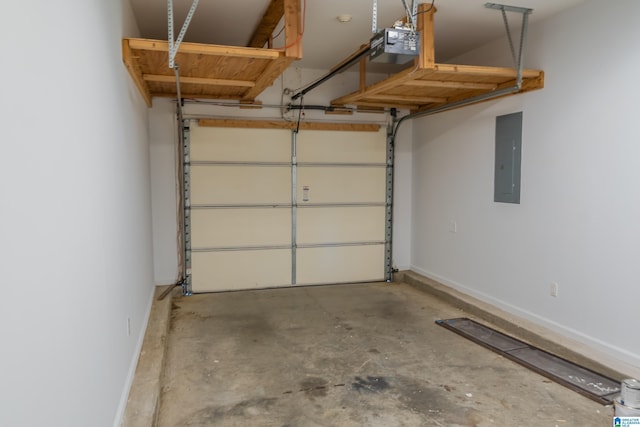 garage featuring baseboards, a garage door opener, and electric panel