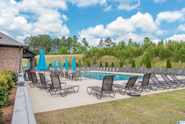 pool featuring fence and a patio area