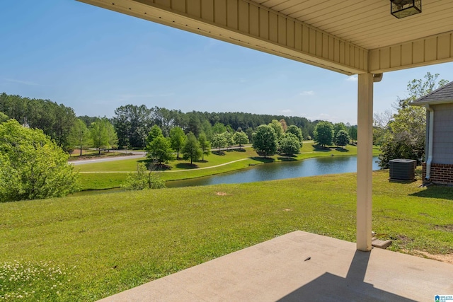 view of yard featuring a water view, cooling unit, and a patio area