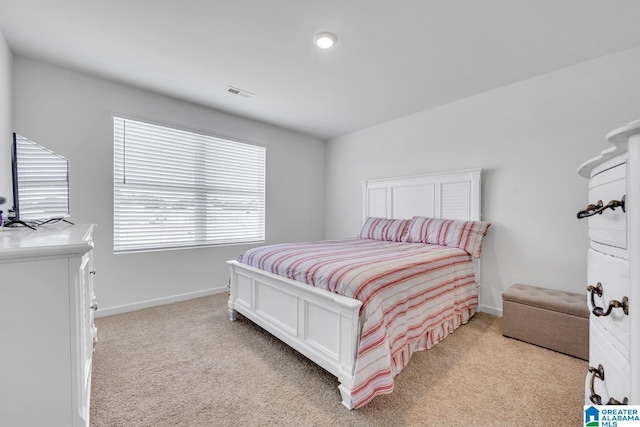 bedroom featuring light colored carpet, baseboards, and visible vents