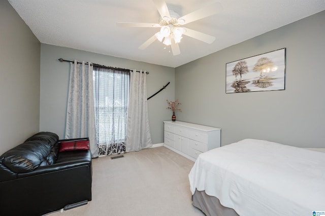 bedroom with ceiling fan, light carpet, and visible vents