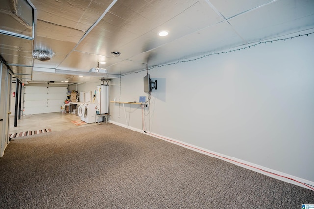 garage with separate washer and dryer, baseboards, recessed lighting, and water heater