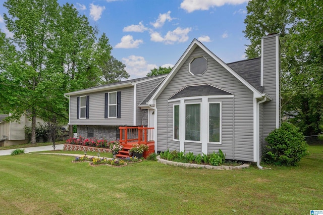 tri-level home with a chimney and a front lawn