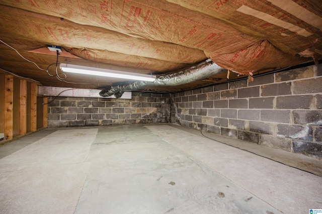 unfinished basement with concrete block wall