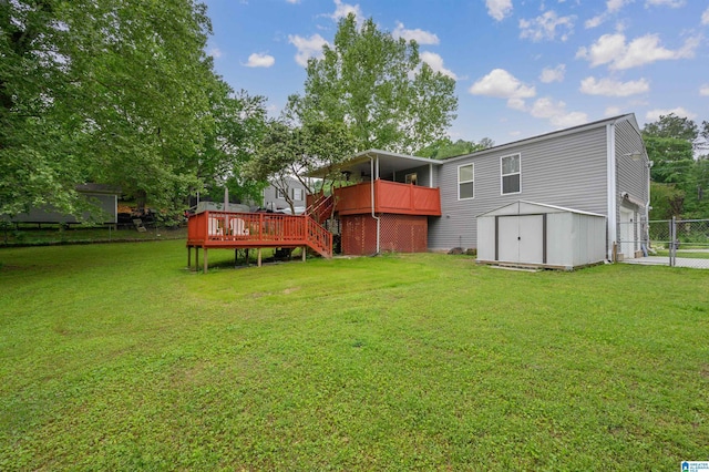 view of yard with fence, a storage unit, a wooden deck, stairway, and an outdoor structure
