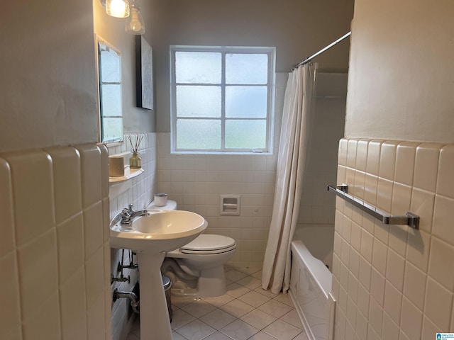 708 Devon Dr, Birmingham, AL 35209 - full bathroom with tile walls, tile patterned floors, toilet, wainscoting, and a sink