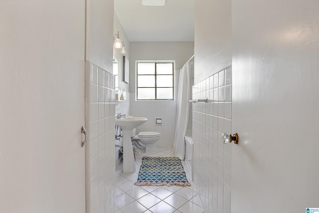 708 Devon Dr, Birmingham, AL 35209 - bathroom with tile patterned flooring, tile walls, toilet, shower / bathtub combination with curtain, and wainscoting