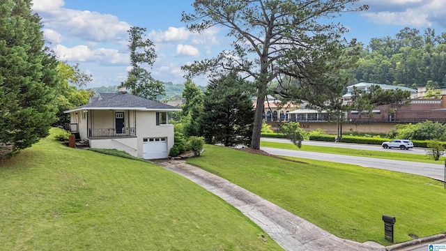 708 Devon Dr, Birmingham, AL 35209 - view of green lawn featuring an attached garage and concrete driveway