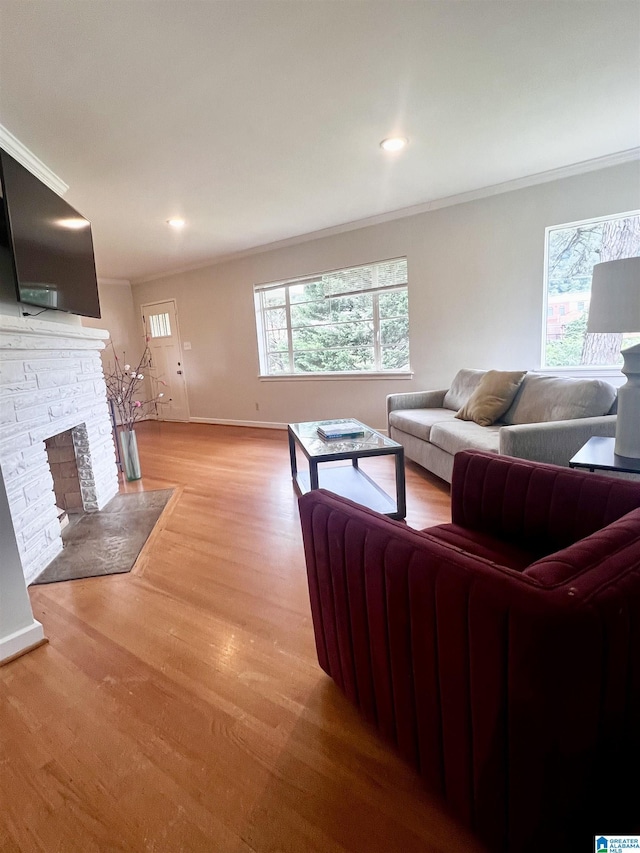 708 Devon Dr, Birmingham, AL 35209 - living room with crown molding, light wood-style flooring, baseboards, a stone fireplace, and recessed lighting