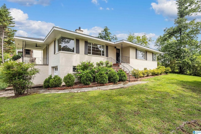 708 Devon Dr, Birmingham, AL 35209 - view of front of home featuring brick siding, a chimney, a front lawn, and a ceiling fan