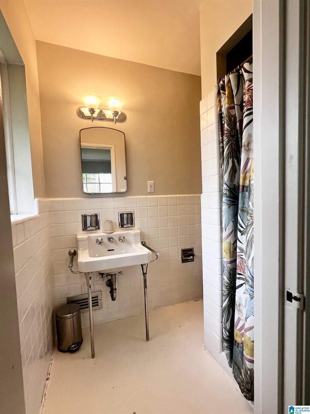 708 Devon Dr, Birmingham, AL 35209 - bathroom featuring tile walls, a wainscoted wall, and a shower with shower curtain