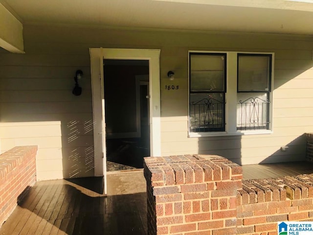 view of exterior entry featuring a porch