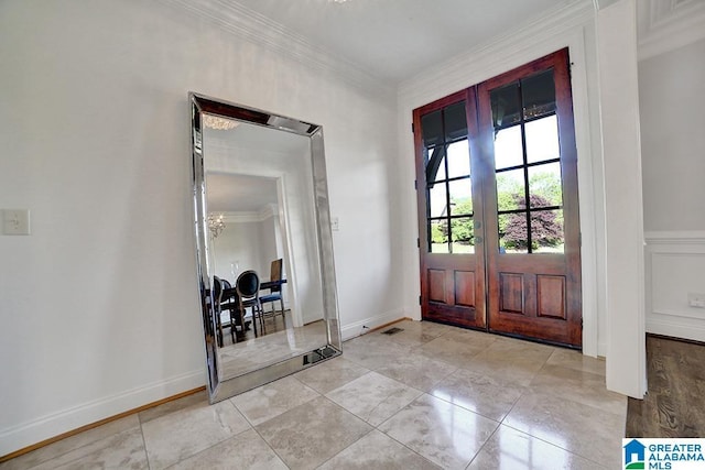 foyer with crown molding, a chandelier, french doors, and visible vents