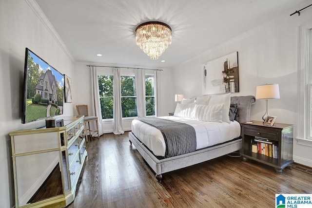 bedroom featuring ornamental molding, wood finished floors, and a notable chandelier