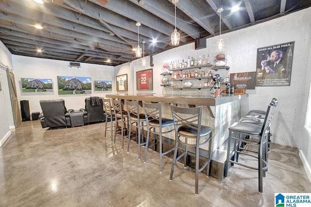 bar with baseboards, a dry bar, and finished concrete floors