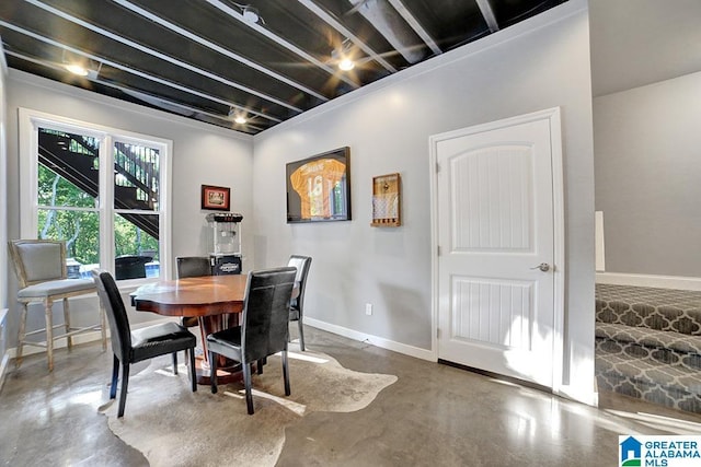 dining space with baseboards and finished concrete flooring