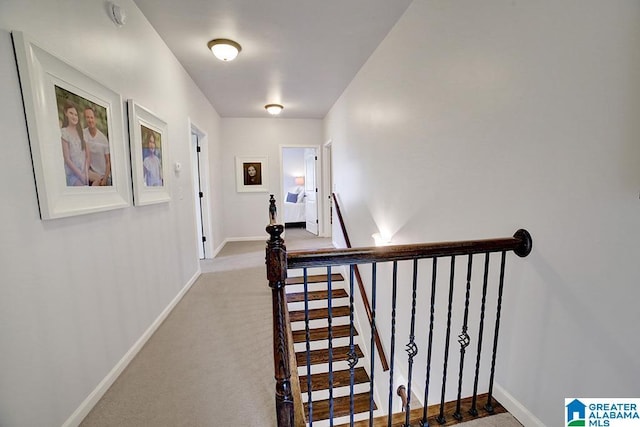 staircase with baseboards and carpet