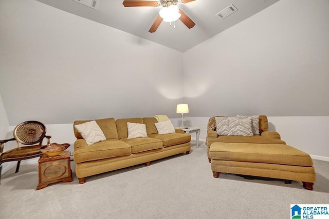 living area featuring visible vents, a ceiling fan, carpet, and vaulted ceiling