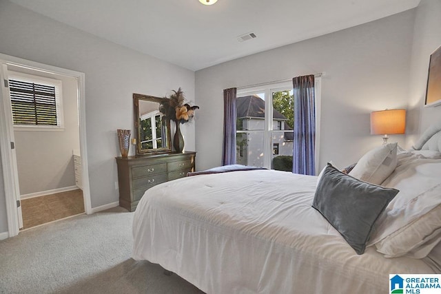 bedroom with carpet floors, baseboards, and visible vents