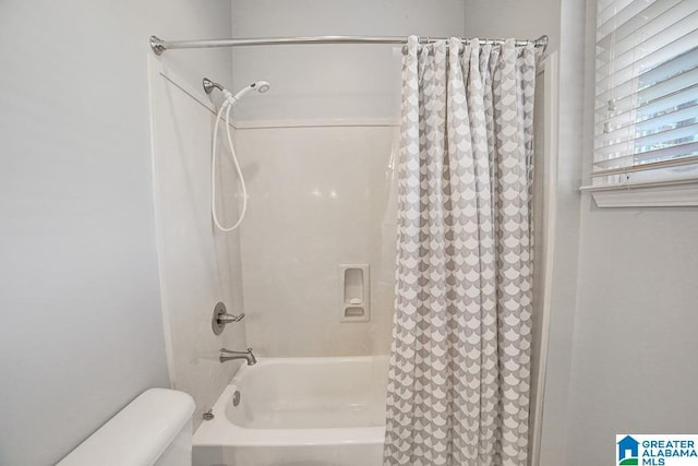 full bathroom featuring toilet and shower / bathtub combination with curtain