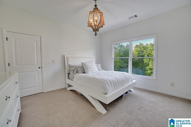 bedroom featuring baseboards, visible vents, light colored carpet, and a chandelier