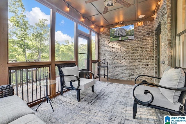 sunroom featuring a healthy amount of sunlight and rail lighting