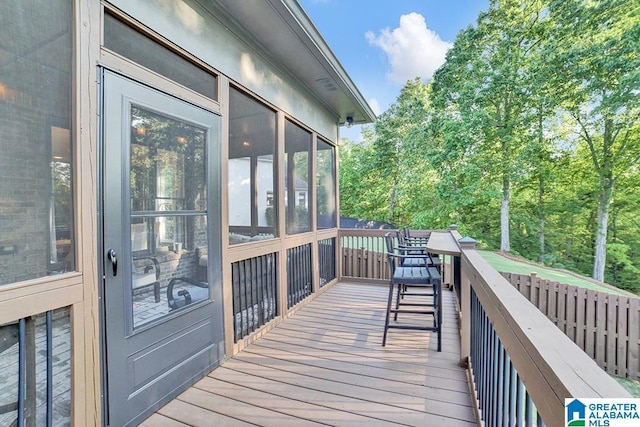 wooden deck featuring a sunroom