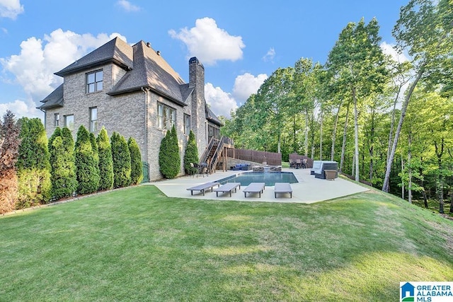 view of yard with a patio area, fence, and stairway