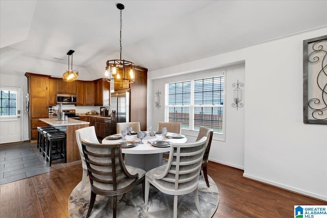 dining room featuring baseboards, a chandelier, lofted ceiling, and dark wood-type flooring